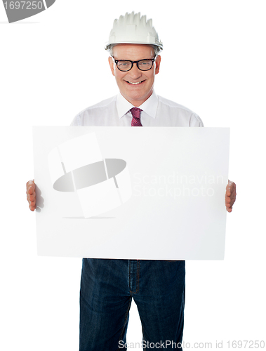 Image of Businessman architect holding a blank white signboard