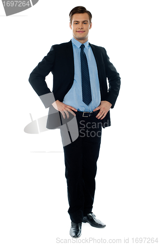 Image of Full length view of a young businessperson posing with hands on his waist