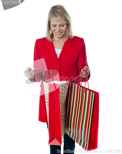 Image of Shppoing woman looking inside empty bag