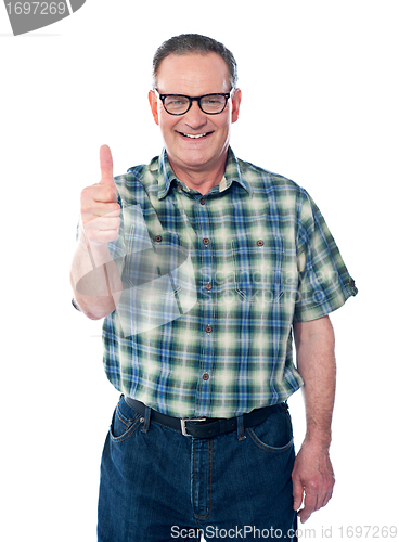 Image of Casual old man showing thumbs-up sign to camera