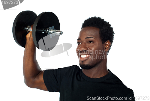 Image of Powerful muscular young man lifting weights