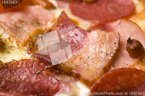 Image of Italian pizza with bacon, salami and mozzarella cheese