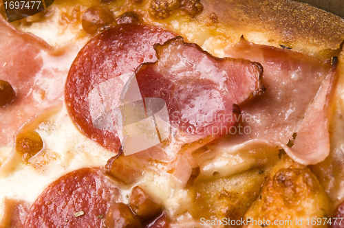 Image of Italian pizza with bacon, salami and mozzarella cheese