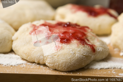 Image of Dough with marmelade on wooden board