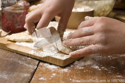 Image of Detail of hands kneading dough