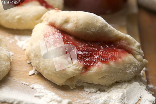 Image of Dough with marmelade on wooden board