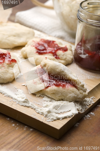 Image of Dough with marmelade on wooden board