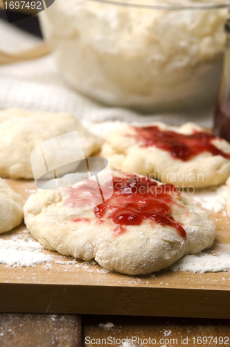 Image of Dough with marmelade on wooden board