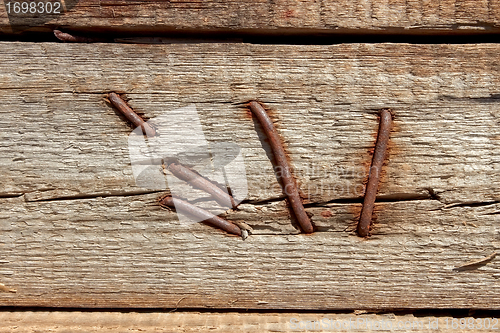 Image of Rusty nails in wooden shield