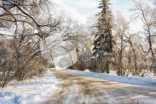 Image of A snow covered road on a cold winter morning
