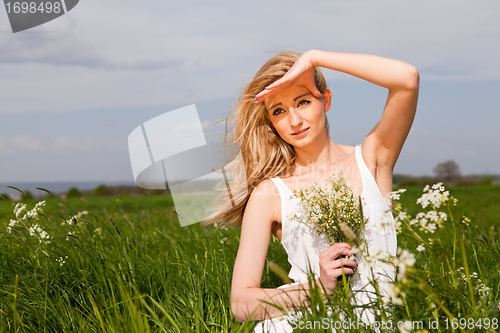 Image of beautiful blonde woman outdoor in summer happy