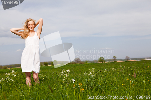 Image of beautiful blonde woman outdoor in summer happy