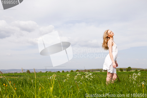 Image of beautiful blonde woman outdoor in summer happy