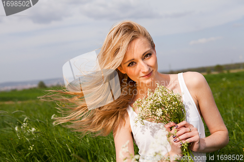 Image of beautiful blonde woman outdoor in summer happy