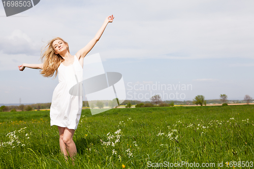 Image of beautiful blonde woman outdoor in summer happy