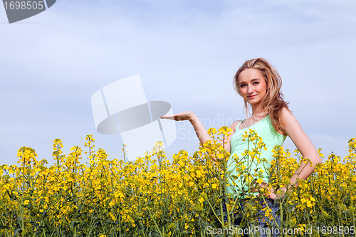 Image of beautiful blonde girl in a field in summer 