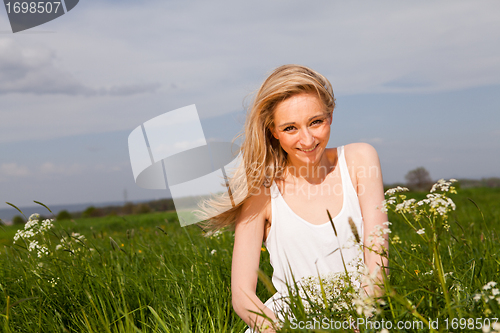 Image of beautiful blonde woman outdoor in summer happy