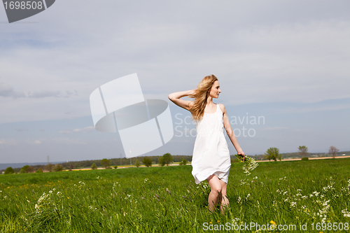 Image of beautiful blonde woman outdoor in summer happy
