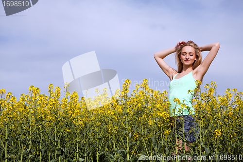 Image of beautiful blonde girl in a field in summer 
