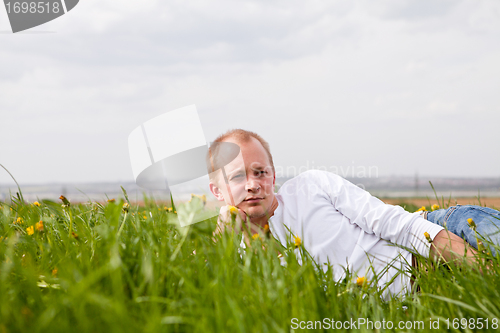 Image of young man outdoor in summer in nature happy