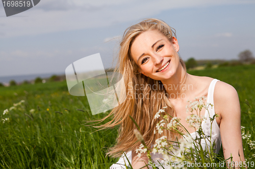 Image of beautiful blonde woman outdoor in summer happy