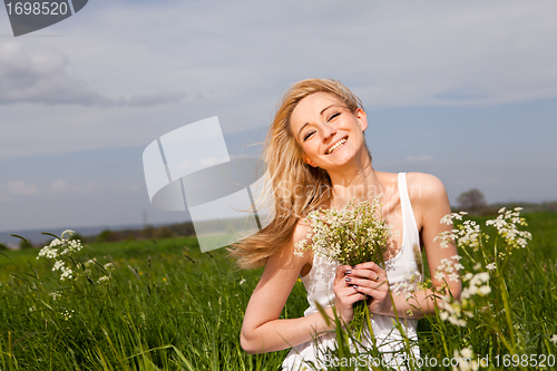 Image of beautiful blonde woman outdoor in summer happy