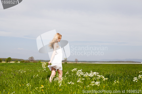 Image of beautiful blonde woman outdoor in summer happy