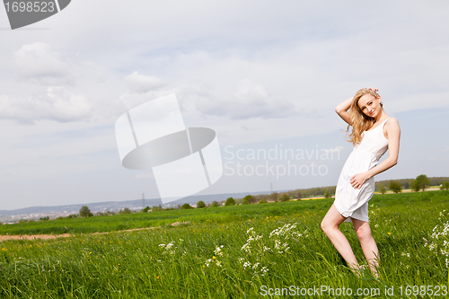 Image of beautiful blonde woman outdoor in summer happy