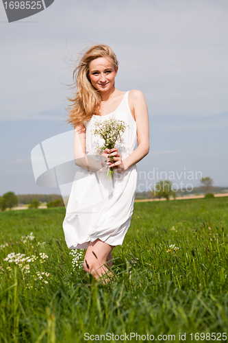 Image of beautiful blonde woman outdoor in summer happy