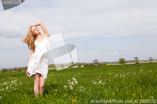 Image of beautiful blonde woman outdoor in summer happy