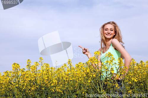 Image of beautiful blonde girl in a field in summer 