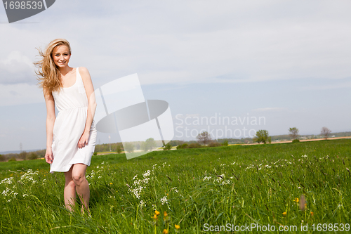 Image of beautiful blonde woman outdoor in summer happy