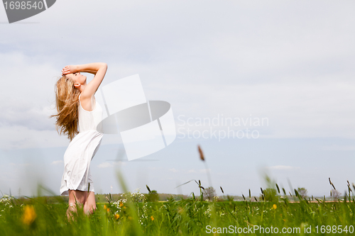 Image of beautiful blonde woman outdoor in summer happy