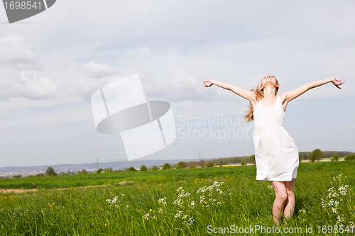 Image of beautiful blonde woman outdoor in summer happy