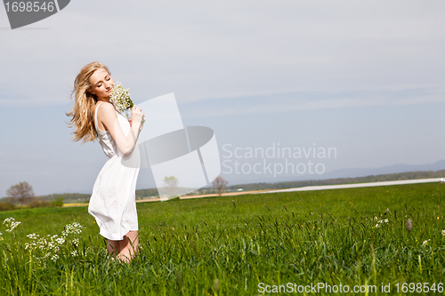 Image of beautiful blonde woman outdoor in summer happy