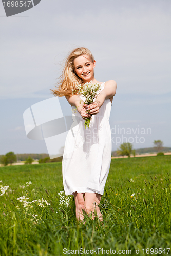 Image of beautiful blonde woman outdoor in summer happy