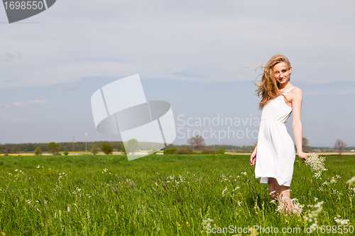 Image of beautiful blonde woman outdoor in summer happy