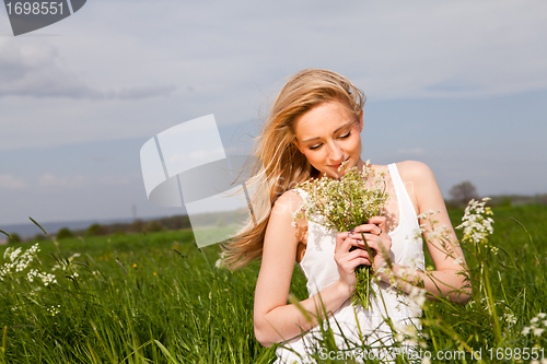 Image of beautiful blonde woman outdoor in summer happy