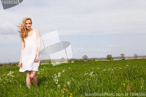 Image of beautiful blonde woman outdoor in summer happy