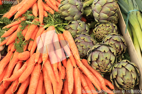 Image of leeks carrots artichokes in spring in a market