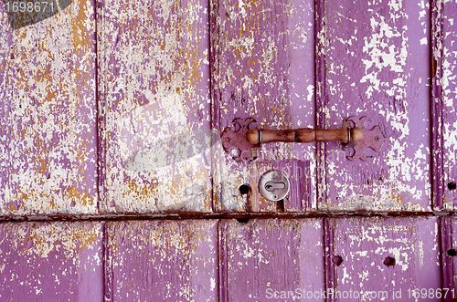 Image of Old painted, crumbled door.