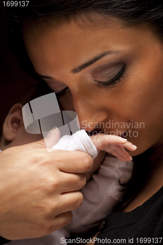 Image of Ethnic Woman Kisses Her Newborn Baby Hand