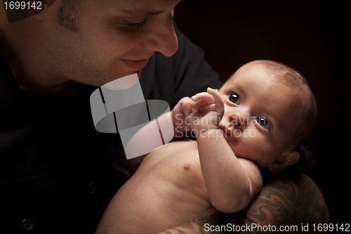 Image of Young Father Holding His Mixed Race Newborn Baby