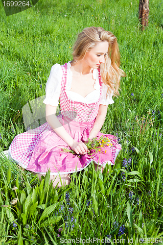 Image of young woman with pink dirndl outdoor