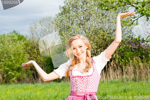 Image of young woman with pink dirndl outdoor