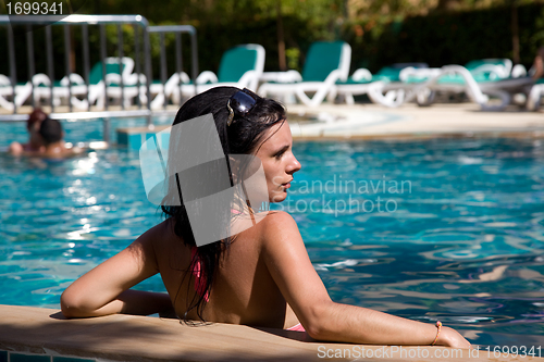 Image of Portrait of a beautiful brunette girl in pool