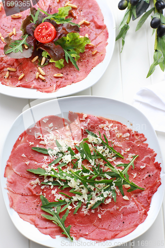 Image of Carpaccio with arugula and cheese