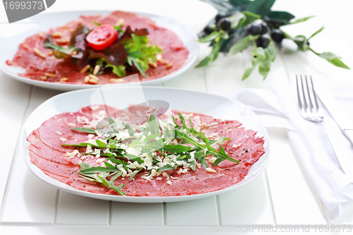 Image of Carpaccio with arugula and cheese