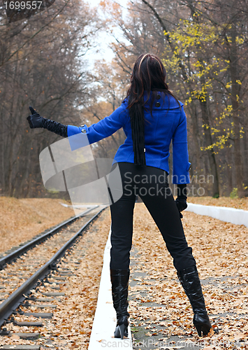 Image of Young woman hitchhiking