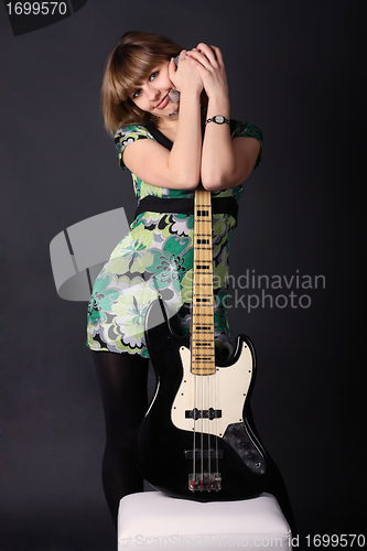 Image of Young beautiful girl with a guitar